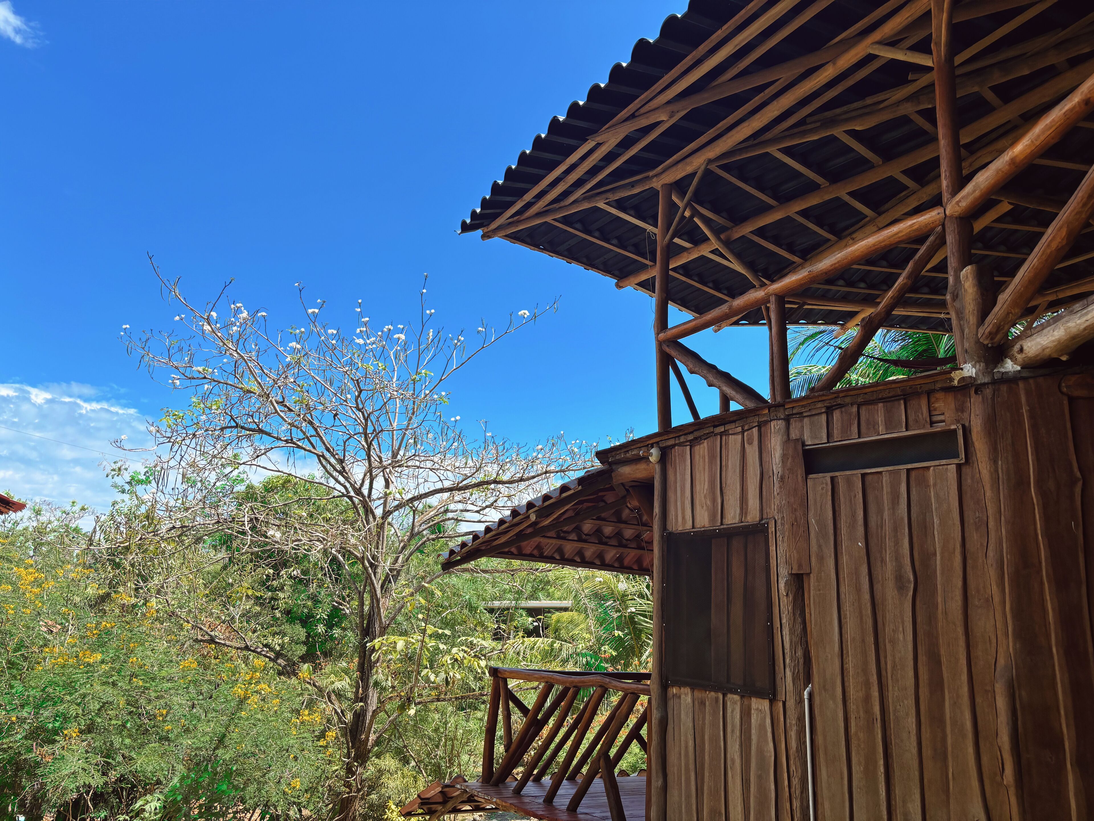 A wooden structure with a wooden deck and a metal railing.