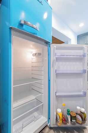 A blue refrigerator with multiple shelves and a freezer compartment. - Modern Crestline Cabin Near Creek & Lake Gregory (Crestline)