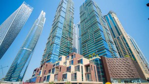 A cluster of high-rise buildings with modern architecture, featuring glass facades and a mix of commercial and residential spaces.