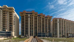 A high-rise residential building with multiple balconies and a central atrium. - January Special! - Remodeled condo on the beach super close to dining and hiking (Orange Beach)