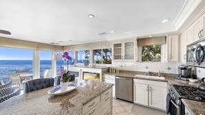A spacious kitchen with a large island, modern appliances, and a view of the ocean. - 3 Unobstructed ocean view direct beach access! Oceanfront Villa with a Spectacular View (C) (Laguna Beach)