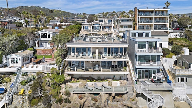 A coastal property with multiple levels, outdoor seating areas, and a rocky shoreline. - 6 Ocean views, direct beach access Sunset Cove Laguna BCH (F) (Laguna Beach)