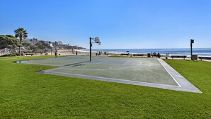 An outdoor basketball court with a clear view of the ocean and beach in the background. - Ocean View Villa, walk to main beach, easy beach access (Laguna Beach)