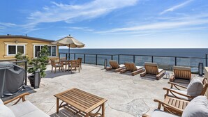 A patio with outdoor furniture, a grill, and a view of the ocean. - Ocean View Villa, walk to main beach, easy beach access (Laguna Beach)