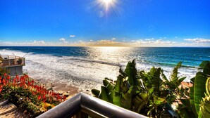 A coastal view with a clear sky, ocean waves, and tropical vegetation. - Breathtaking Views Savor the Sunset, Relax (Laguna Beach)
