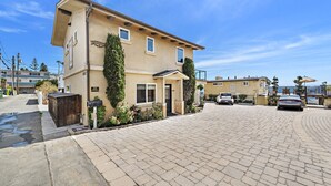 A residential building with a paved driveway and parked cars. - Breathtaking Views Savor the Sunset, Relax (Laguna Beach)