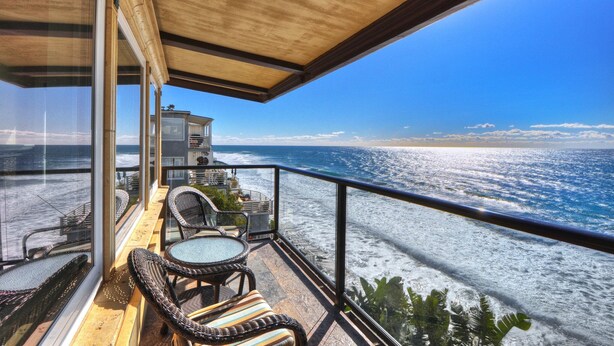 A balcony with wicker furniture and a view of the ocean. - Ocean views steps to the water prime Laguna Beach 8 Villa Roma (Laguna Beach)