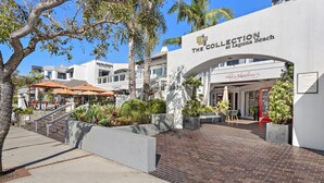 A modern building with a sign reading "The Collection at Laguna Beach."