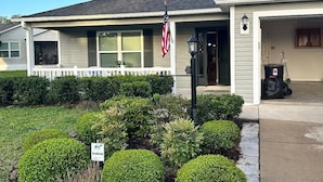 A residential house with a garage, a lawn, and a dog-walk sign. - Rare find in Historic Orange Blossom 3/2 with golf cart (Lady Lake)