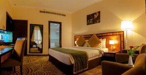 Relax in comfort with a large bed, desk, and seating area.