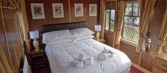 A carefully converted  heritage railway coach in the countryside.