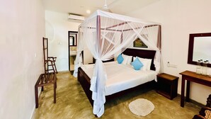 A bedroom with a four-poster bed, a bedside table, a mirror, and a ceiling fan. - The White House Villa (Ahangama)