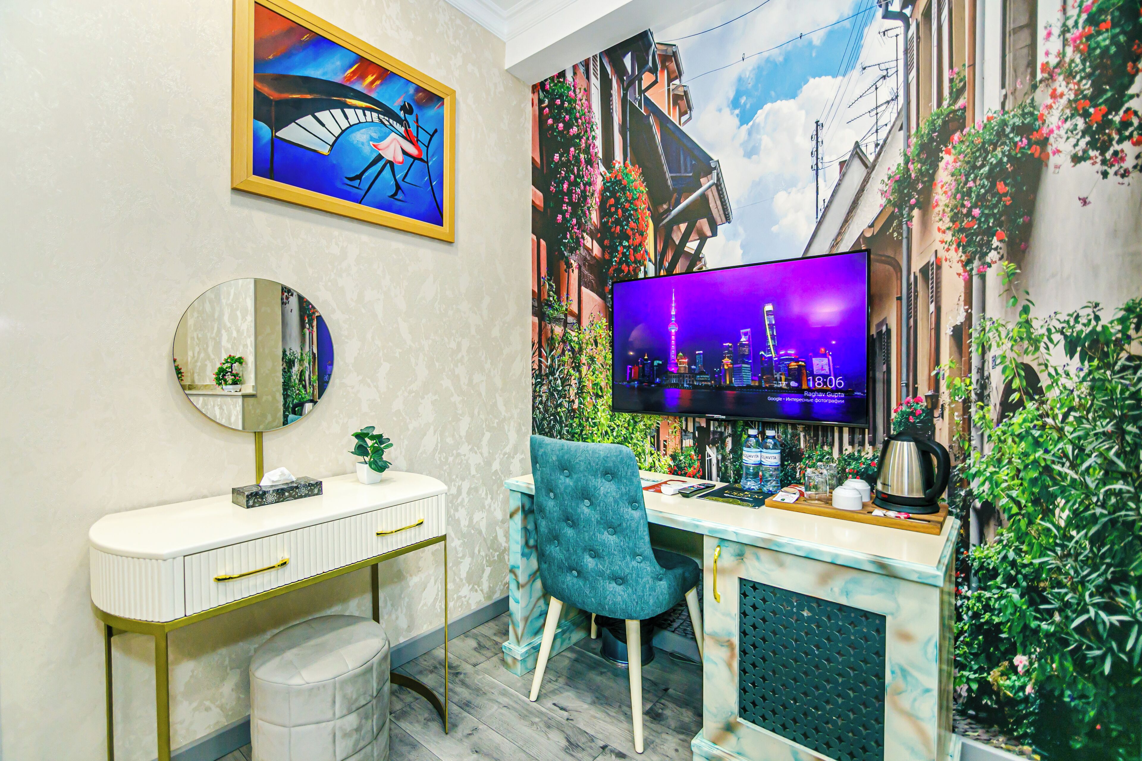 A modern room with a desk, chair, and a large TV.