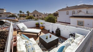A rooftop terrace with a sofa, a small table, and potted plants. - Spanish villa with private pool , only 5 minutes from the beach! (San Pedro de Alcantara)