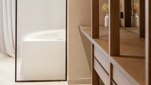 A room with a sliding door, a mirror, and a shelf with vases. - Sevasti Seaview Suite (Rhodes)