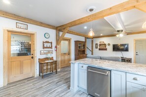 Enjoy casual dining and socializing in this well-appointed kitchen with a central island, seating area, and large window.