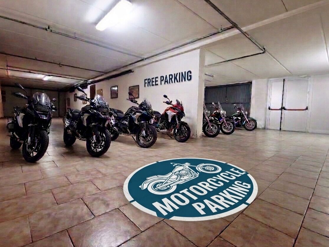 Ein Motorradstellplatz mit einem Schild, das kostenlose Parkplätze anzeigt.