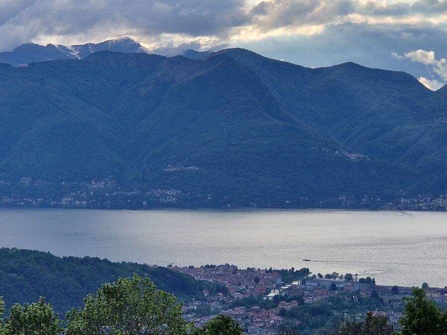 A mountainous landscape with a lake and a town in the foreground.