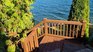A wooden deck with a railing overlooking a body of water. - LoZa House rooftop SkyDeck lakefront  Pets Hot Tub (Plattsburgh)