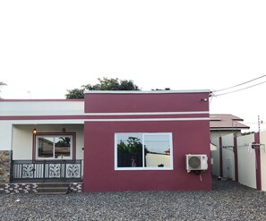 Guests can enjoy a balcony with a railing, a large window with a frame, and a convenient entrance.