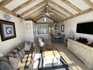 A spacious living area with a high ceiling, a dining table, a sofa, and a kitchen in the background. - Villa Costa Teguise (Costa Teguise)