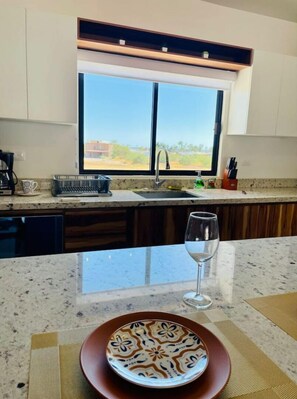 Enjoy a view of the surrounding countryside from this kitchen's large window.