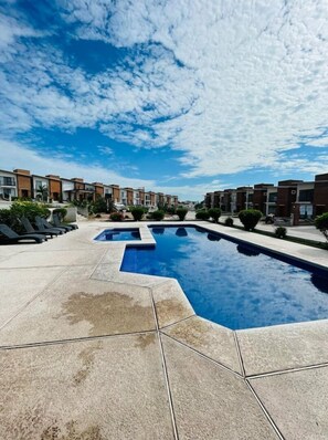 Guests can enjoy a refreshing swim in the pool surrounded by a spacious deck.