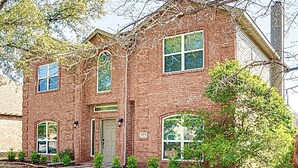 A two-story brick building with a central entrance, two side entrances, and a large window on the second floor. - Spa & Pool + Stay in Harry Potter Theme Home (Frisco)