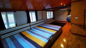 A room with a large bed, a window, and a wooden ceiling. - Cozy, friendly, surroundings with nature ,Thai culture and  life style. (Nasuan Srisawat)