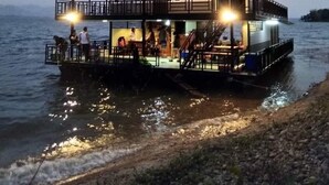 A multi-level houseboat with a balcony and outdoor seating area, situated on a body of water. - Cozy, friendly, surroundings with nature ,Thai culture and  life style. (Nasuan Srisawat)