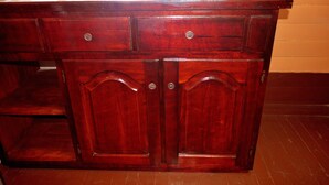 A wooden bathroom vanity with a sink, two drawers, and a cabinet.