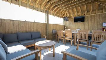 Community gathering space with comfortable seating and dining areas.