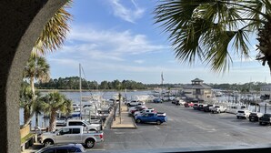 A marina with boats docked, a parking area, and a view of the water. - Reel Em Inn (Carrabelle)
