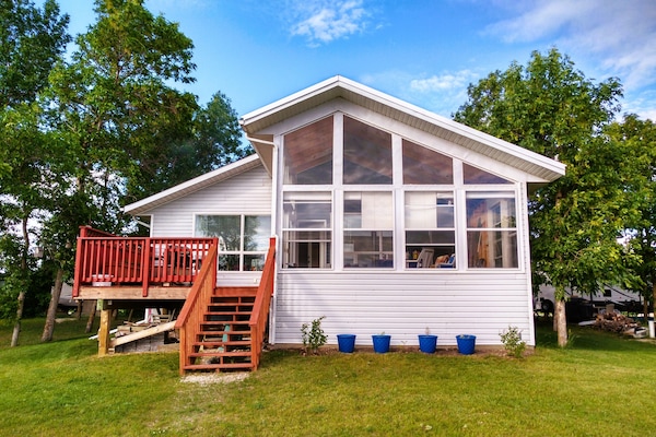 Exterior view of the house, on the lake side, showing deck and sunroom.