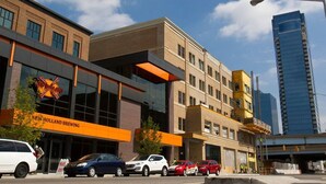 A modern building with a prominent sign for New Holland Brewing. - Grand Rapids Dayton Station! (Grand Rapids)
