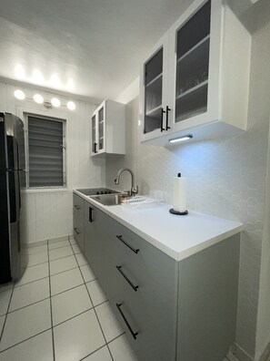 Fridge, microwave, coffee/tea maker, cookware/dishes/utensils