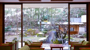 A traditional Japanese-style interior with tatami flooring, low wooden tables, and green upholstered chairs. - Ooedo Onsen Monogatari Kounkaku (Osaki)
