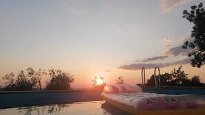 A swimming pool with an inflatable mattress and a pool ladder.