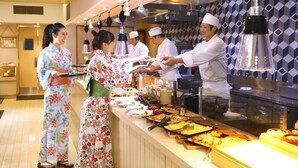 A buffet setup with various dishes and a serving counter. - Ooedo Onsen Monogatari Masuya (Osaki)