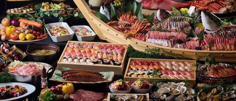 A variety of seafood and meats displayed on wooden trays and platters.