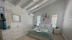 A bedroom with a bed, dresser, and nightstands.