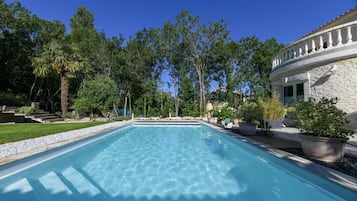 Seasonal outdoor pool, open 9:30 AM to 8:00 PM, pool umbrellas