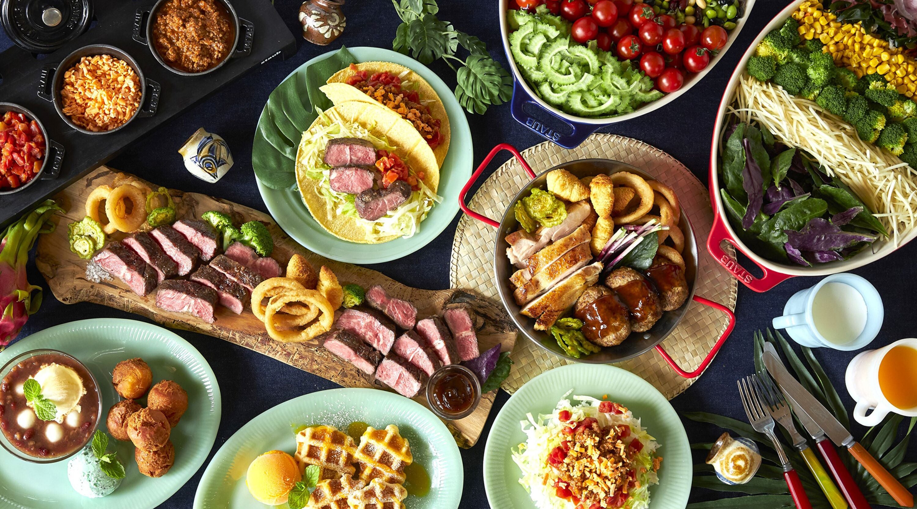 A variety of dishes including tacos, steak, and salads, suggesting a diverse meal selection.