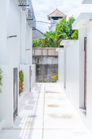 Stroll through this serene courtyard, surrounded by lush greenery and a soothing water feature.