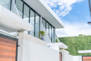 Experience the unique blend of modern architecture and natural surroundings, with a green wall and spacious balconies offering a tranquil retreat.