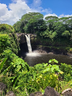 A waterfall in a lush, green forest setting. - Air Conditioned 2 Bedrooms 1 Bath Apartment, fine decorated, Free Laundry in HPP (Keaau)