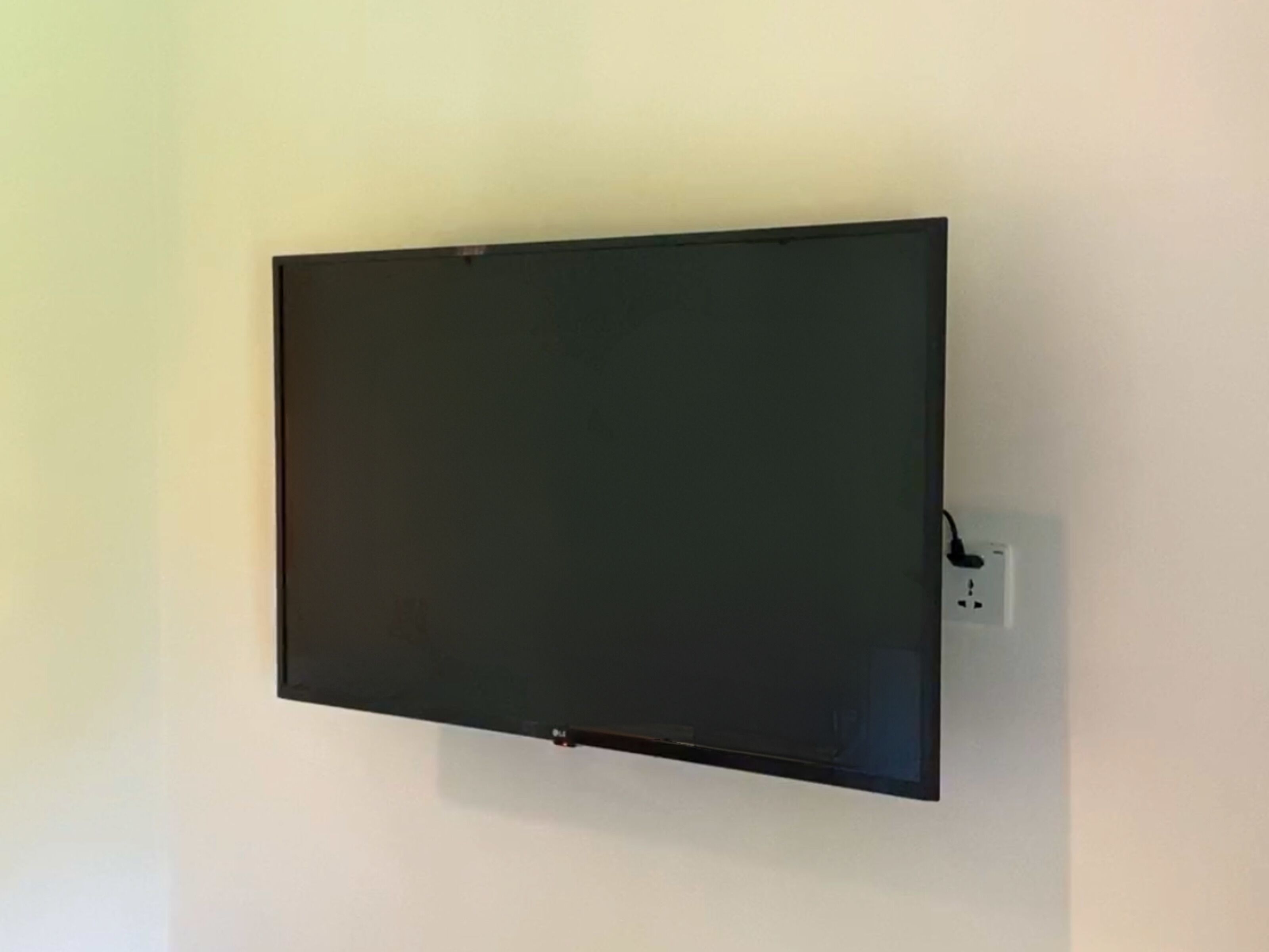 A flat-screen TV mounted on a plain wall.