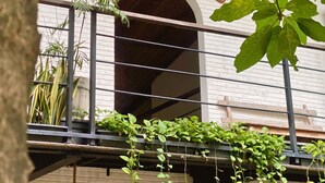 A hostel sign with the name "WHITE PENNY HOSTEL" above an arched entrance. - White Penny Hostel (Keroboken Kelod)