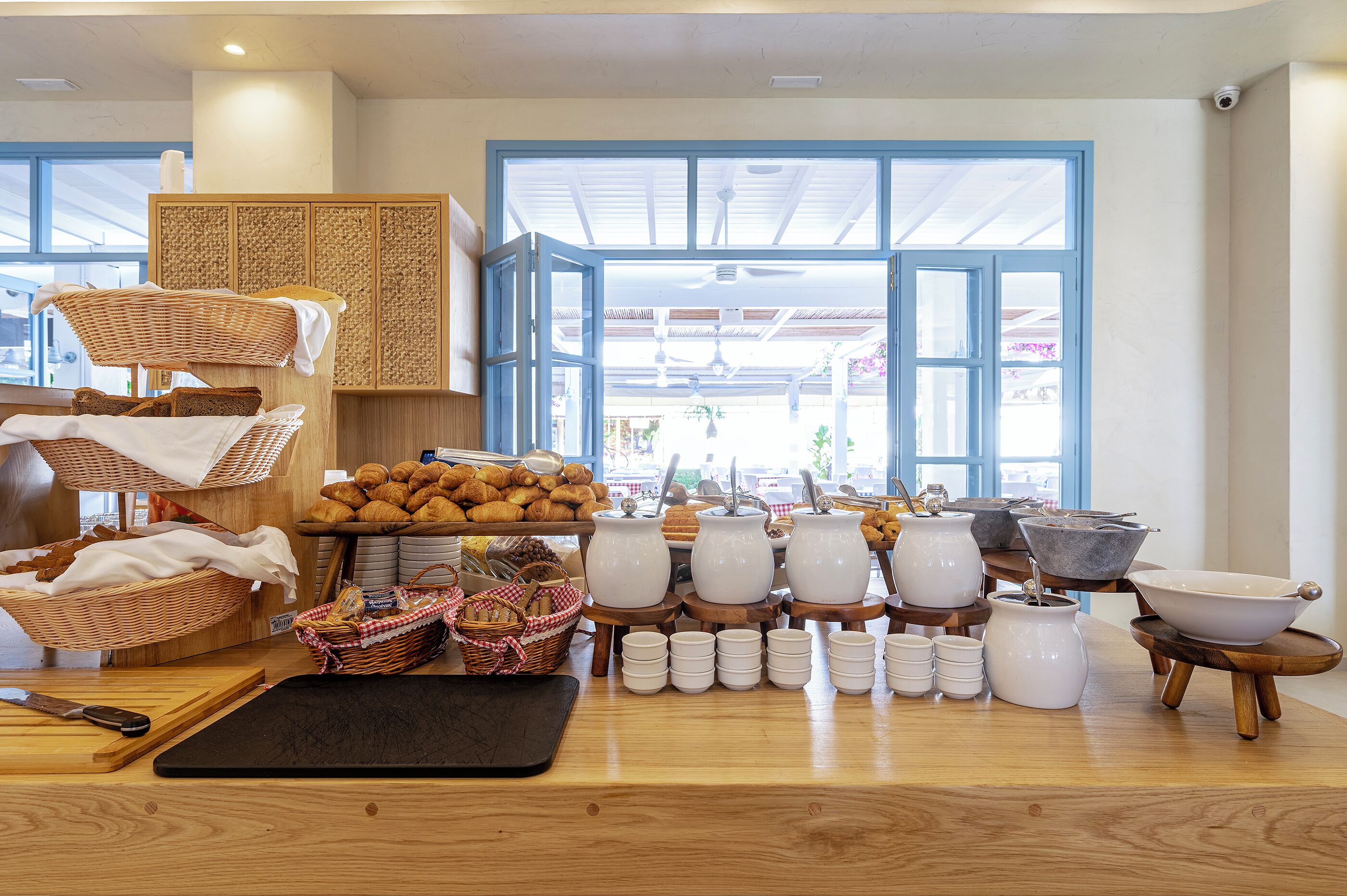A bakery with various baked goods, kitchenware, and baskets.