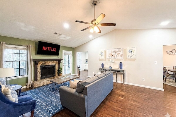 Spacious living room with modern décor, fireplace, and ample seating